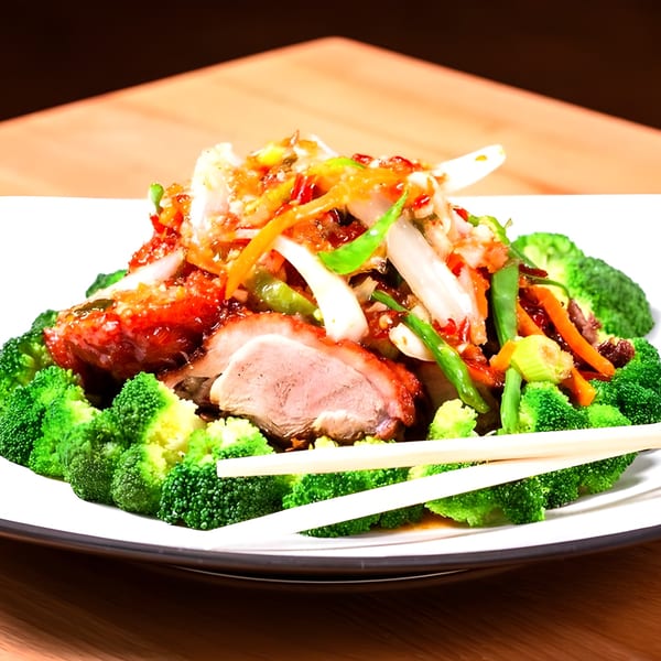 Pattaya Kitchen's roasted duck with broccoli and mixed vegetables, served with chopsticks.